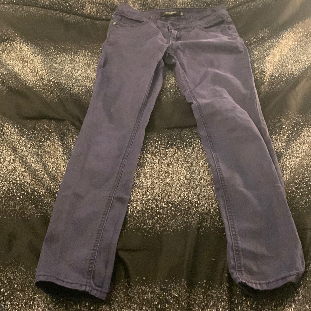 Blue and black colored jeans